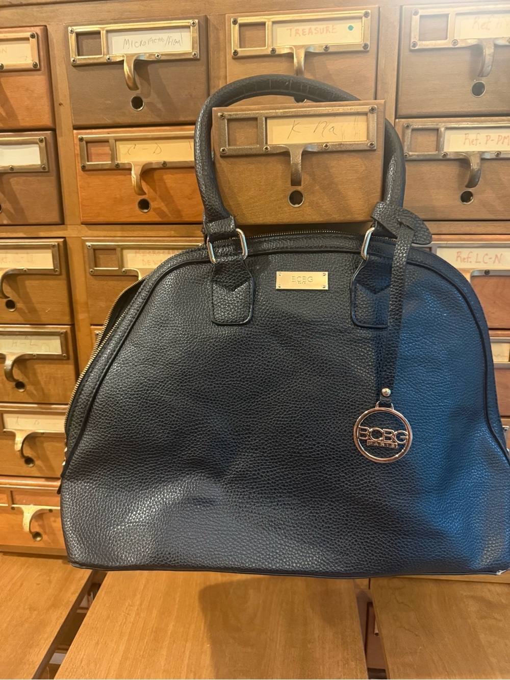 BCBG Black Pebble Leather Dome Satchel with Logo Charm
